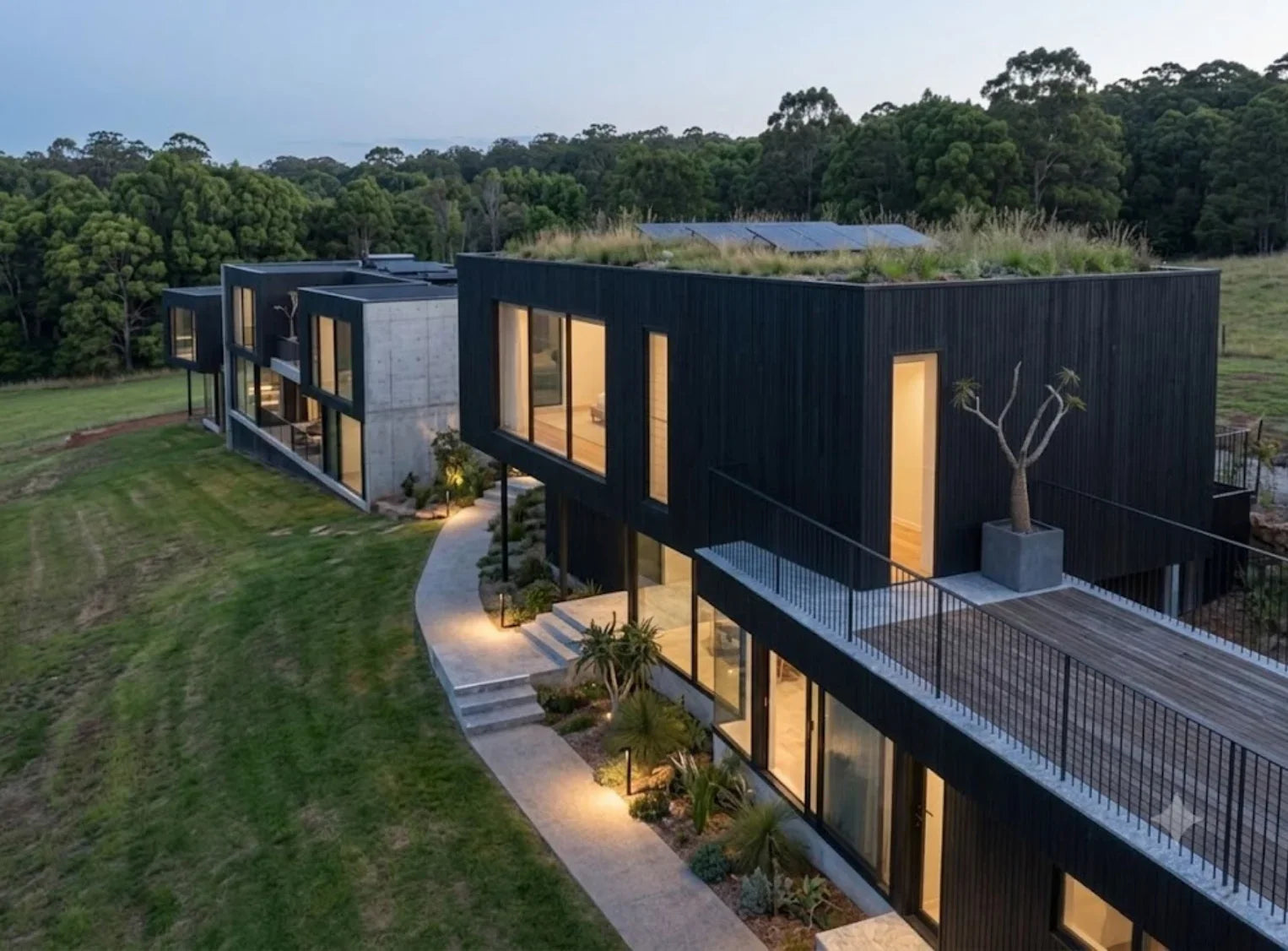Modern house with a green roof and well-maintained garden